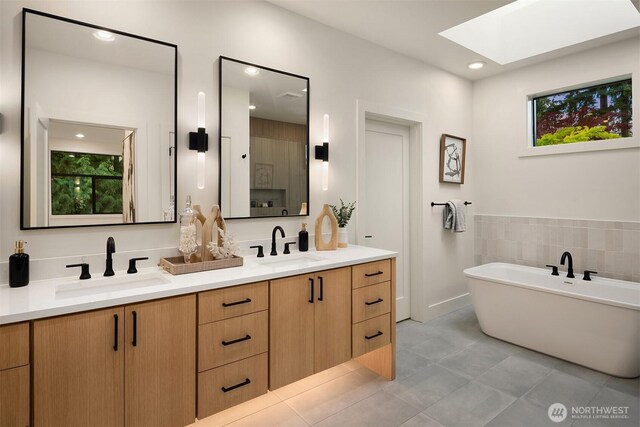 2505 166th Ave SE, Bellevue, WA 98008 - bathroom featuring a skylight, double vanity, tile patterned flooring, and a freestanding bath
