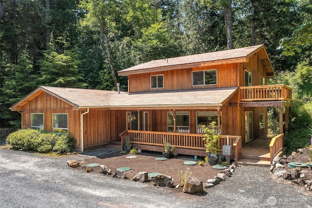 101 Tomihi Dr, Orcas Island, WA 98245 - chalet / cabin featuring covered porch and a forest view