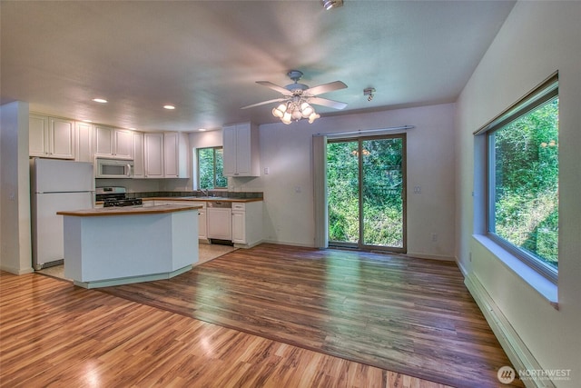 101 Tomihi Dr, Orcas Island, WA 98245 - kitchen with white appliances, a sink, white cabinetry, light wood-style flooring, and a ceiling fan