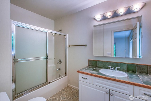 101 Tomihi Dr, Orcas Island, WA 98245 - bathroom featuring vanity, shower / bath combination with glass door, toilet, and tile patterned flooring