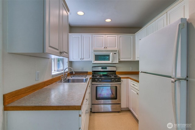 101 Tomihi Dr, Orcas Island, WA 98245 - kitchen featuring white appliances, a sink, recessed lighting, and white cabinetry