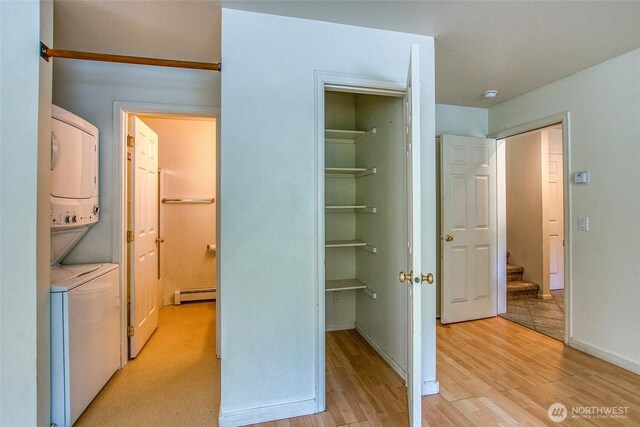 101 Tomihi Dr, Orcas Island, WA 98245 - closet featuring a baseboard radiator and stacked washing machine and dryer