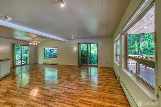 101 Tomihi Dr, Orcas Island, WA 98245 - empty room with baseboard heating, wood finished floors, and baseboards