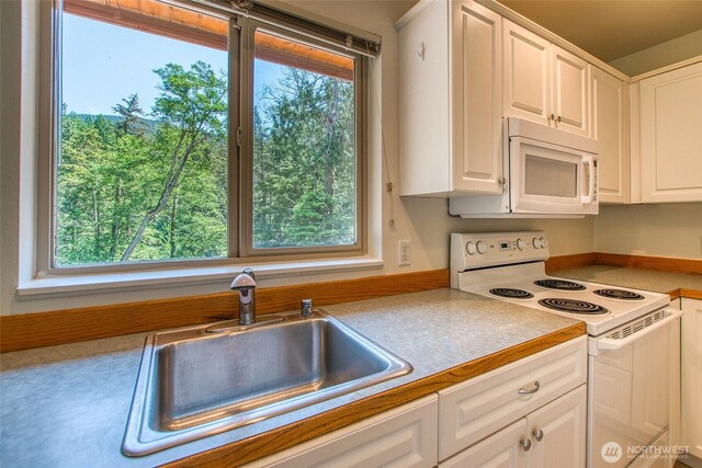 101 Tomihi Dr, Orcas Island, WA 98245 - kitchen featuring white appliances, a sink, light countertops, and white cabinets