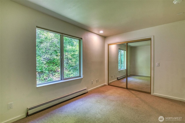 101 Tomihi Dr, Orcas Island, WA 98245 - unfurnished bedroom featuring baseboard heating, carpet flooring, baseboards, a closet, and recessed lighting