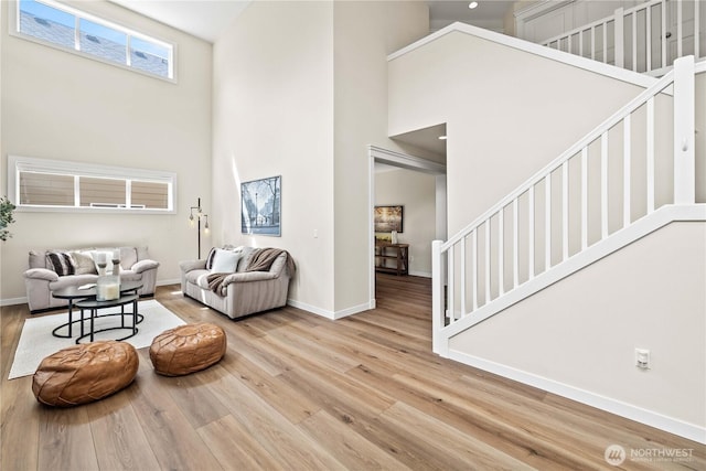 3098 SE 16th St, North Bend, WA 98045 - living room with a towering ceiling, stairway, wood finished floors, and baseboards