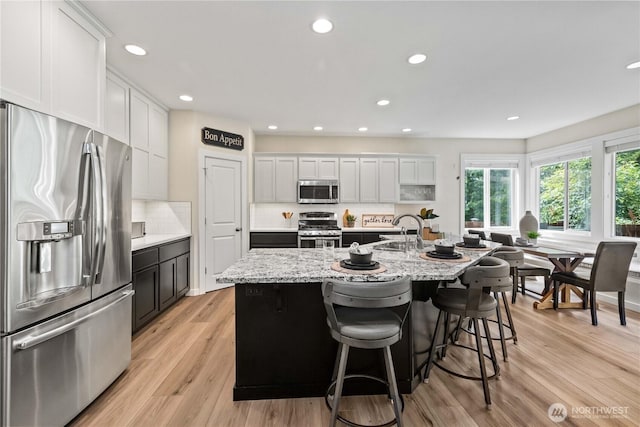 3098 SE 16th St, North Bend, WA 98045 - kitchen featuring appliances with stainless steel finishes, recessed lighting, a sink, backsplash, and white cabinets