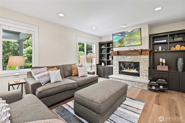 3098 SE 16th St, North Bend, WA 98045 - living area with wood finished floors, a stone fireplace, and recessed lighting