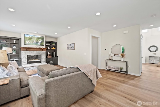 3098 SE 16th St, North Bend, WA 98045 - living room featuring light wood finished floors, a stone fireplace, recessed lighting, and baseboards