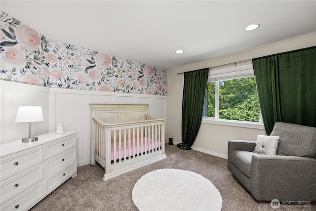 3098 SE 16th St, North Bend, WA 98045 - bedroom featuring light carpet, a wainscoted wall, recessed lighting, a crib, and wallpapered walls