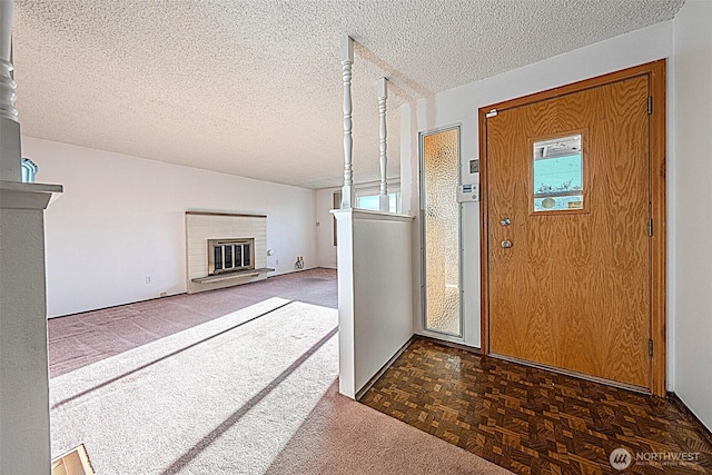 24427 14th Ave S, Des Moines, WA 98198 - carpeted entrance foyer featuring a fireplace and a textured ceiling
