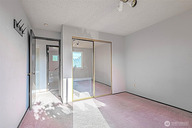 24427 14th Ave S, Des Moines, WA 98198 - unfurnished bedroom featuring a textured ceiling, carpet floors, and a closet