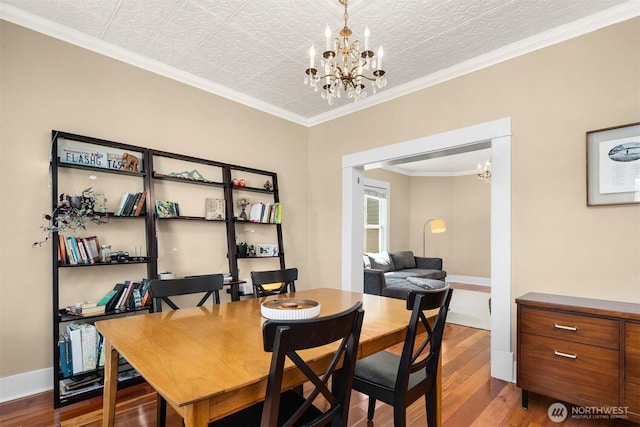 2321 Elm St, Bellingham, WA 98225 - dining space with a chandelier, wood finished floors, crown molding, and baseboards