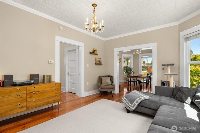 2321 Elm St, Bellingham, WA 98225 - living area with a chandelier, wood finished floors, crown molding, and baseboards