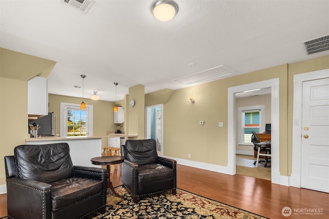2321 Elm St, Bellingham, WA 98225 - living area with attic access, wood finished floors, and baseboards