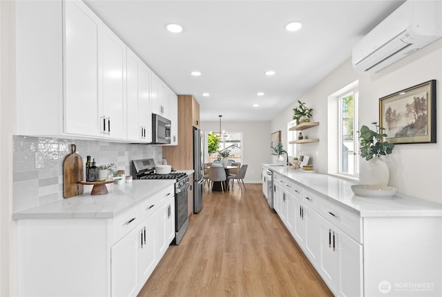 5041 Bowen Pl S, Seattle, WA 98118 - kitchen with appliances with stainless steel finishes, a wall unit AC, light wood-type flooring, open shelves, and tasteful backsplash
