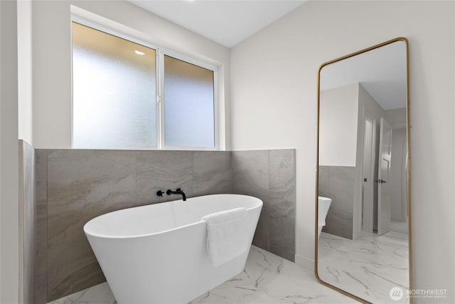 5041 Bowen Pl S, Seattle, WA 98118 - full bathroom with marble look tiles and a freestanding bath