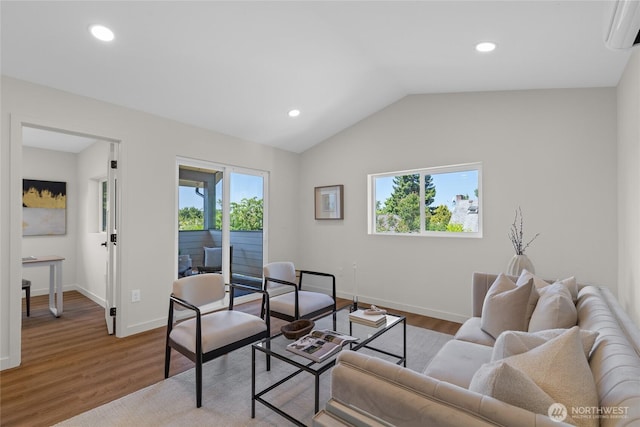 5041 Bowen Pl S, Seattle, WA 98118 - living area featuring a wall mounted air conditioner, healthy amount of natural light, baseboards, wood finished floors, and lofted ceiling
