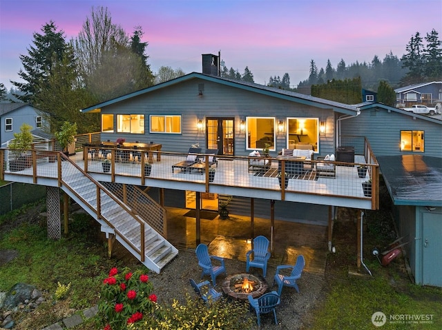 1083 N Vista Del Monte St, Camano Island, WA 98282 - rear view of house featuring an outdoor fire pit, a wooden deck, french doors, and outdoor dining space