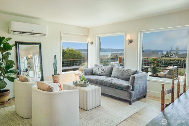 1083 N Vista Del Monte St, Camano Island, WA 98282 - living area featuring a wall mounted air conditioner, light wood-style floors, and plenty of natural light