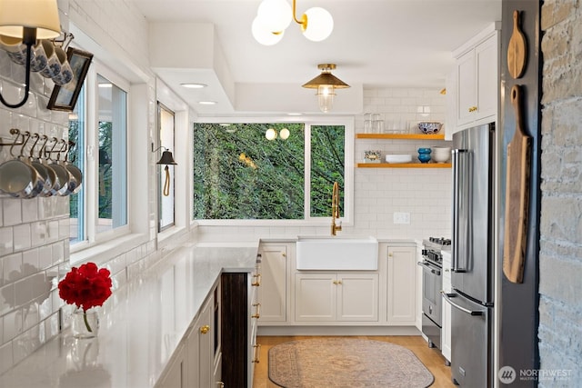 1083 N Vista Del Monte St, Camano Island, WA 98282 - kitchen with stainless steel appliances, a sink, light countertops, white cabinets, and open shelves