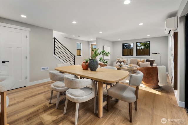 3720 36th Ave SW Unit B, Seattle, WA 98126 - dining area with an AC wall unit, light wood finished floors, stairway, baseboards, and recessed lighting