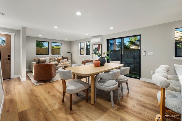 3720 36th Ave SW Unit B, Seattle, WA 98126 - dining room featuring a wall mounted air conditioner, baseboards, light wood-type flooring, plenty of natural light, and recessed lighting