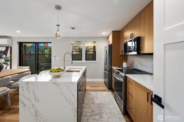 3720 36th Ave SW Unit B, Seattle, WA 98126 - kitchen featuring appliances with stainless steel finishes, a sink, brown cabinets, a wall mounted AC, and recessed lighting