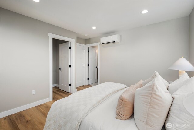 3720 36th Ave SW Unit B, Seattle, WA 98126 - bedroom with a wall mounted AC, baseboards, wood finished floors, and recessed lighting
