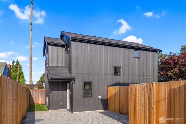 3720 36th Ave SW Unit B, Seattle, WA 98126 - back of property featuring a fenced backyard and a patio