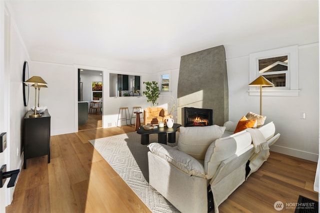 3722 36th Ave SW, Seattle, WA 98126 - living area featuring wood finished floors, a large fireplace, and baseboards