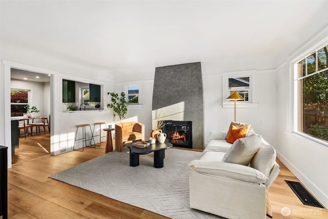 3722 36th Ave SW, Seattle, WA 98126 - living room featuring a large fireplace and wood finished floors