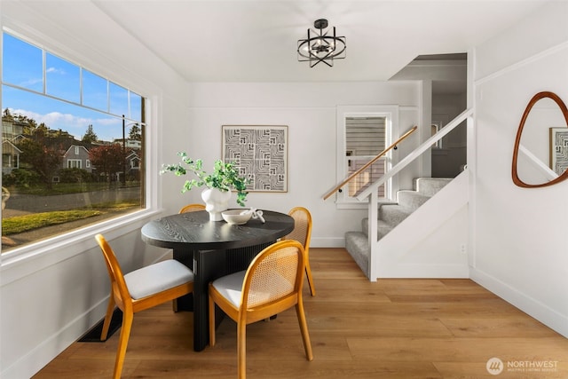 3722 36th Ave SW, Seattle, WA 98126 - dining space featuring stairs, baseboards, and wood finished floors