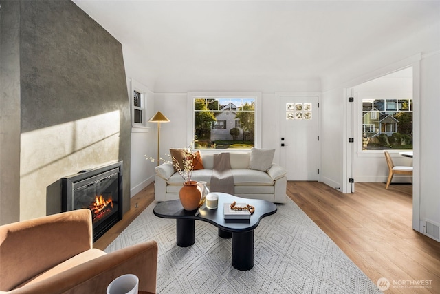 3722 36th Ave SW, Seattle, WA 98126 - living area with wood finished floors, a glass covered fireplace, and baseboards