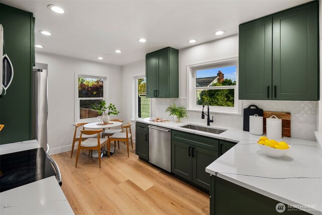 3722 36th Ave SW, Seattle, WA 98126 - kitchen featuring green cabinets, dishwasher, a sink, plenty of natural light, and recessed lighting