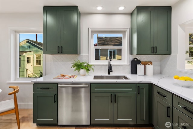 3722 36th Ave SW, Seattle, WA 98126 - kitchen featuring green cabinets, stainless steel dishwasher, a sink, light stone counters, and backsplash