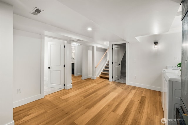 3722 36th Ave SW, Seattle, WA 98126 - finished basement with stairs, baseboards, washer and clothes dryer, recessed lighting, and light wood-style flooring