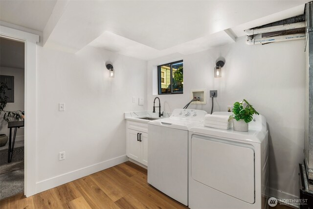 3722 36th Ave SW, Seattle, WA 98126 - laundry area with cabinet space, washer and clothes dryer, light wood-style floors, and baseboards