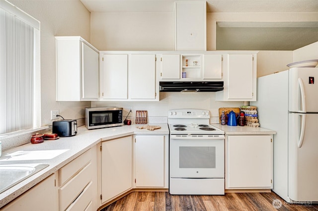 424 Maranatha, Kelso, WA 98626 - kitchen with white appliances, range hood, light countertops, light wood-style floors, and white cabinets