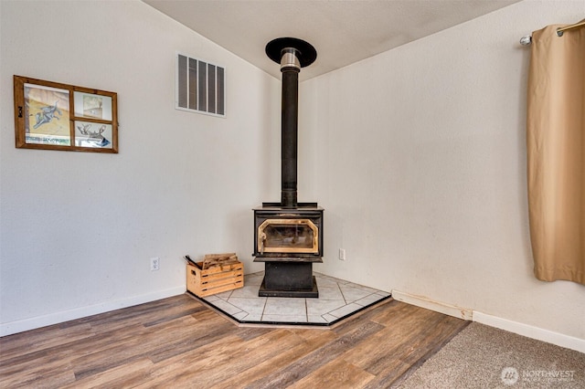 424 Maranatha, Kelso, WA 98626 - detailed view of a wood stove, wood finished floors, and baseboards