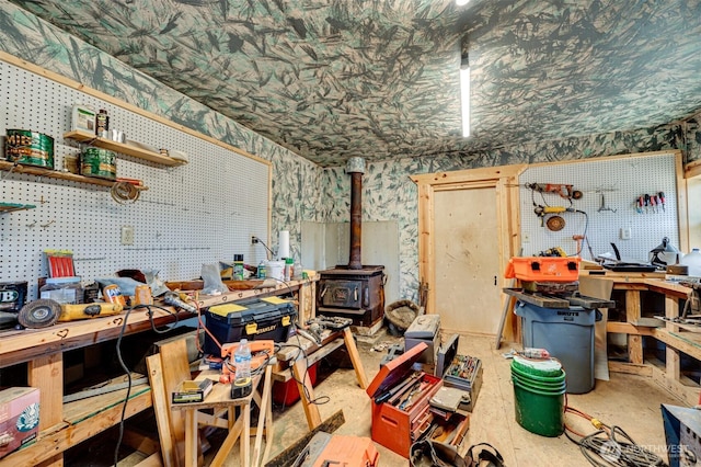 424 Maranatha, Kelso, WA 98626 - misc room featuring a workshop area, a wood stove, and wallpapered walls
