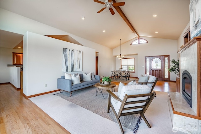 8022 Makah Rd, Blaine, WA 98230 - living room with light wood-type flooring, beam ceiling, a tile fireplace, a ceiling fan, and a chandelier