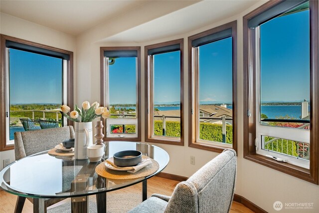 8022 Makah Rd, Blaine, WA 98230 - dining room with a water view, wood finished floors, and baseboards