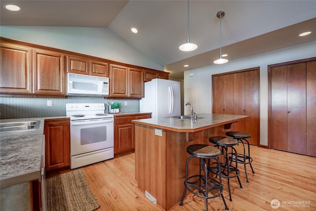 8022 Makah Rd, Blaine, WA 98230 - kitchen featuring white appliances, light wood-style flooring, a sink, a kitchen island with sink, and recessed lighting