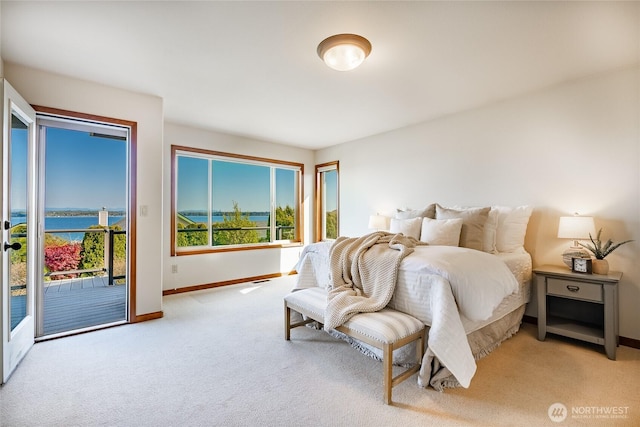 8022 Makah Rd, Blaine, WA 98230 - bedroom with access to exterior, baseboards, light carpet, and a water view