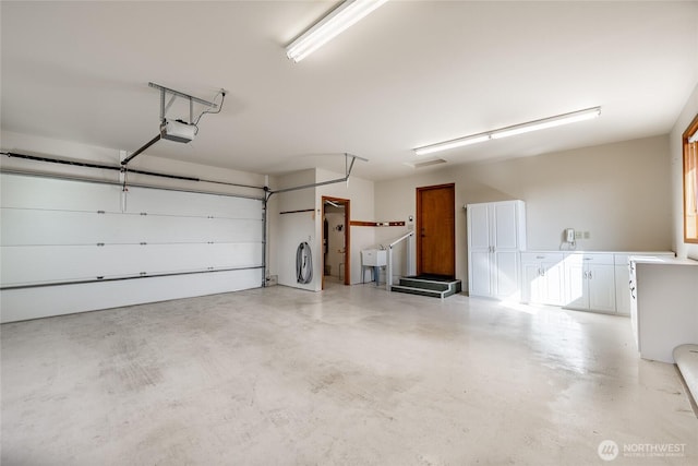 8022 Makah Rd, Blaine, WA 98230 - garage featuring a garage door opener and a sink