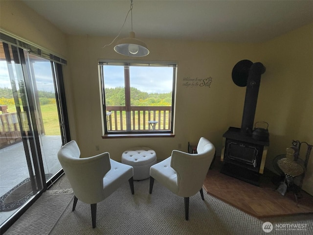 2855 Forrest St S Unit 102, Westport, WA 98595 - sitting room with healthy amount of natural light, a wood stove, and tile patterned floors
