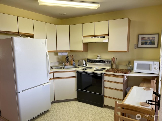 2855 Forrest St S Unit 102, Westport, WA 98595 - kitchen featuring white appliances, under cabinet range hood, a sink, light floors, and light countertops