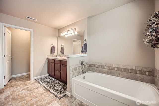 4306 Maple St SE, Olympia, WA 98501 - bathroom with vanity, a bath, and stone finish floors
