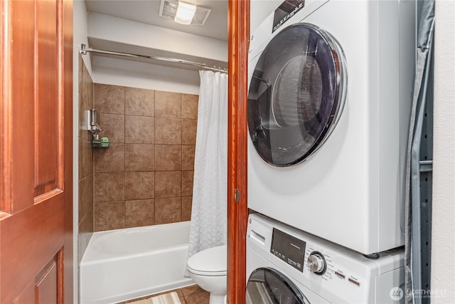 322 W Woodin Ave Unit 620, Chelan, WA 98816 - bathroom featuring stacked washer / dryer, toilet, shower / tub combo with curtain, and tile patterned flooring